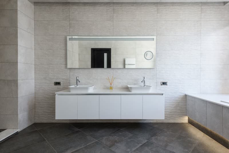 Modern bathroom with a floating double vanity and tiled walls